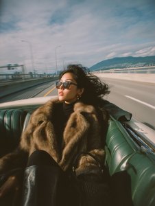 Fashionable Asian Woman Driving Convertible Portrait